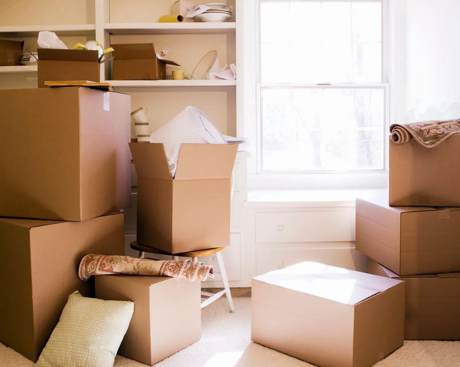 A room with a lot of cardboard boxes stacked on top of each other