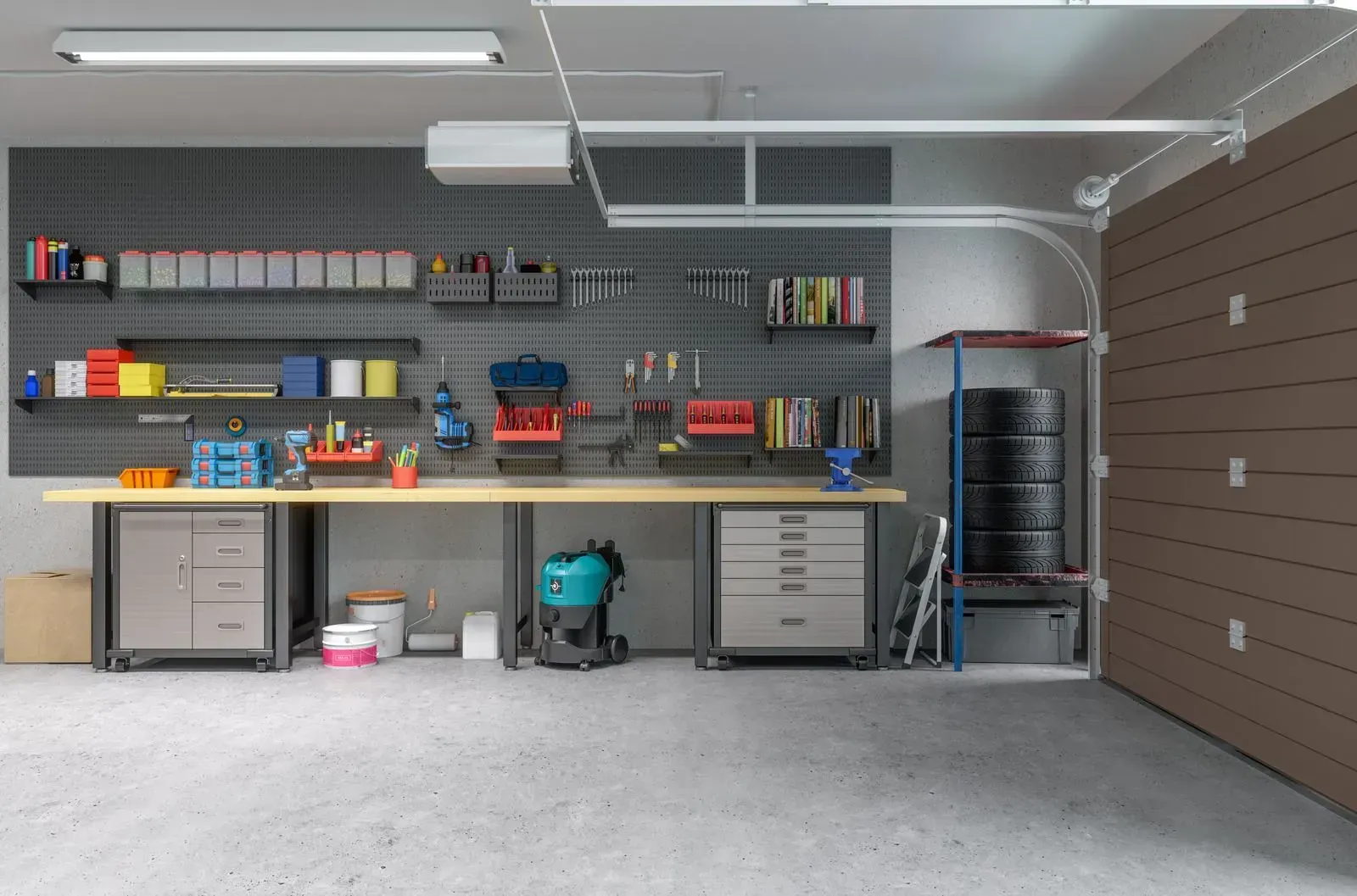 An empty garage with a workbench and a garage door open.