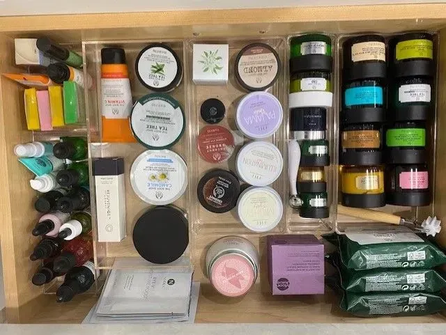 A drawer filled with lots of cosmetics and wipes.