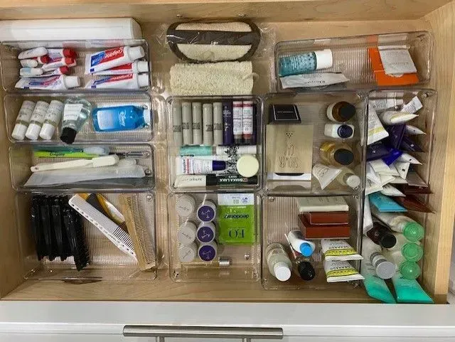 A bathroom drawer filled with lots of toiletries and cosmetics.