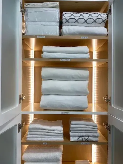 A closet filled with lots of white towels and sheets