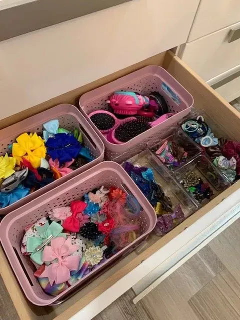 A drawer filled with a variety of hair accessories