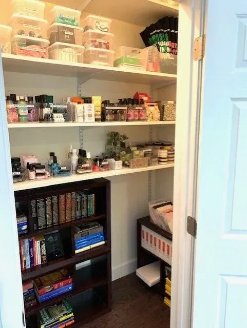 A closet filled with lots of shelves and books