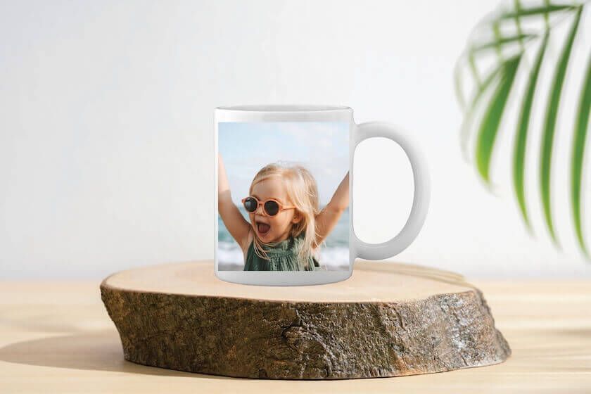 A white coffee mug with a picture of a man and a woman on it