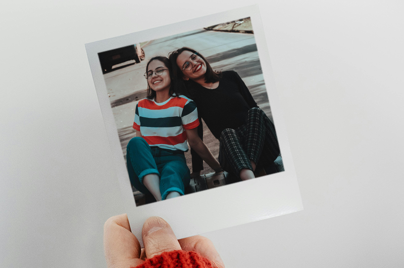 Polaroid with a picture of 2 women