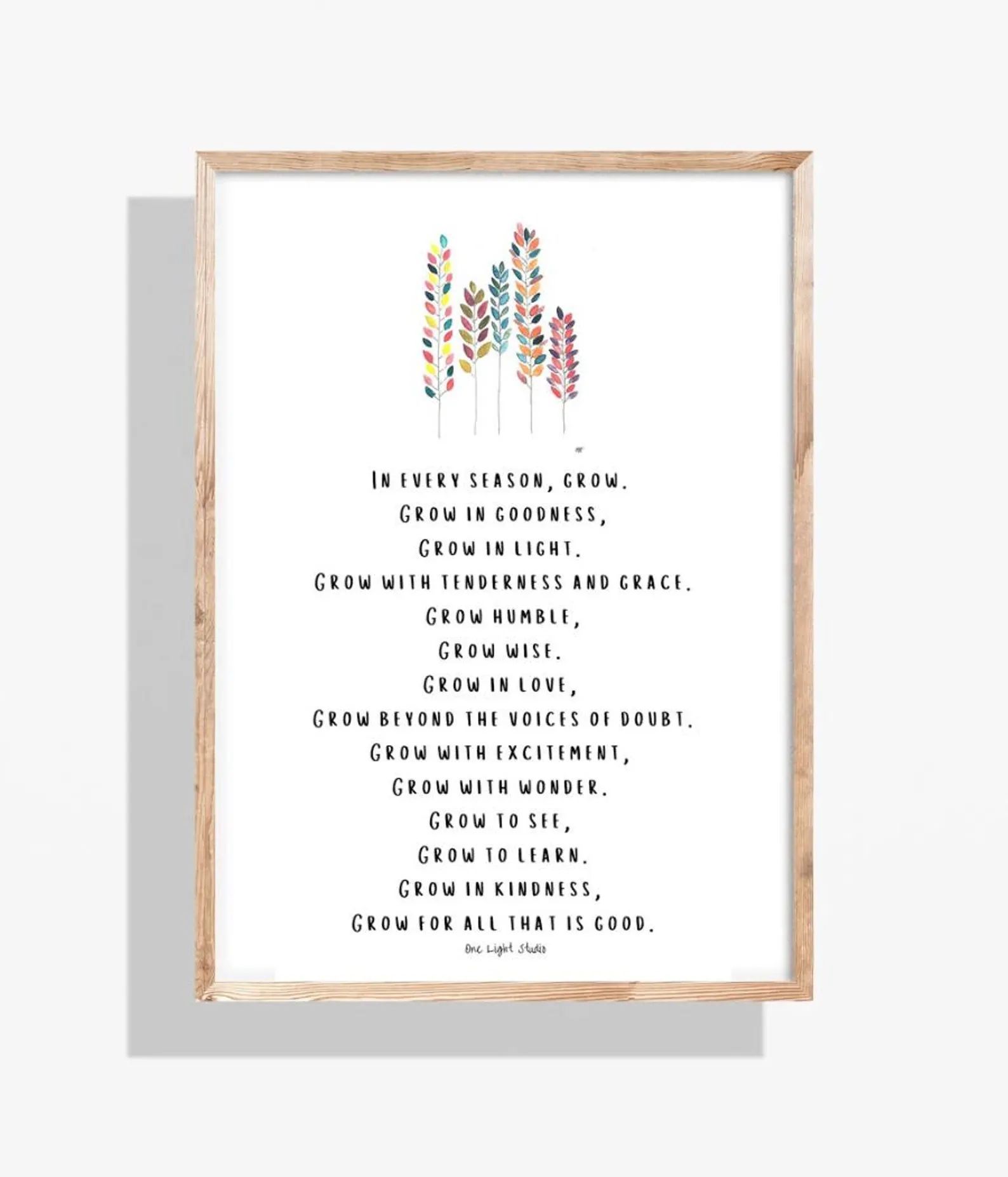 Framed print with a poem about growth, colorful floral illustrations at top. Beige frame, white background, dark text.