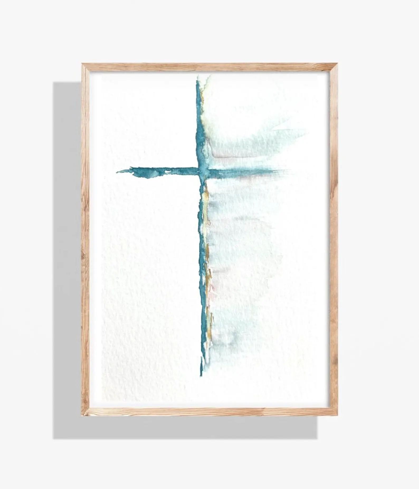 Watercolor painting of a teal cross, framed in wood, against a white background.