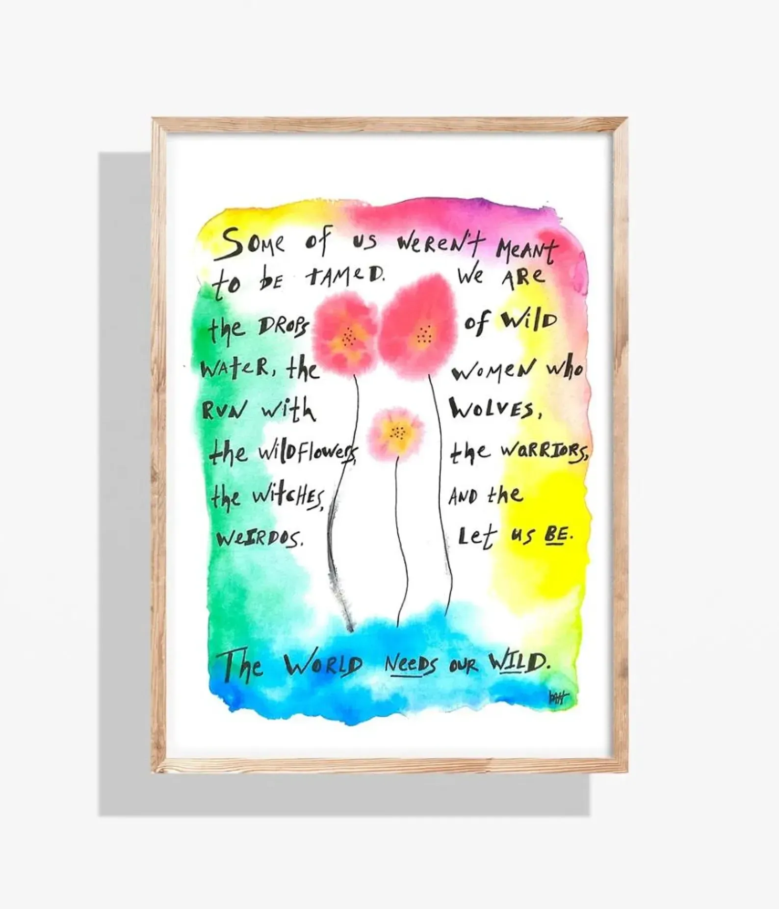 Watercolor art: quote about wild women with flowers and colorful background, in a wooden frame.