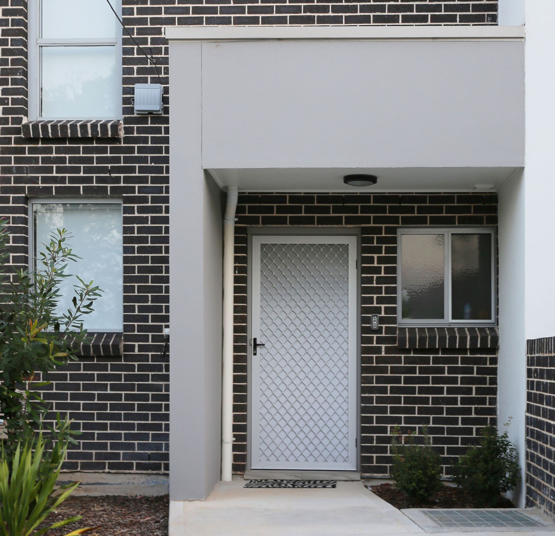 White hinged security front door on modern town house