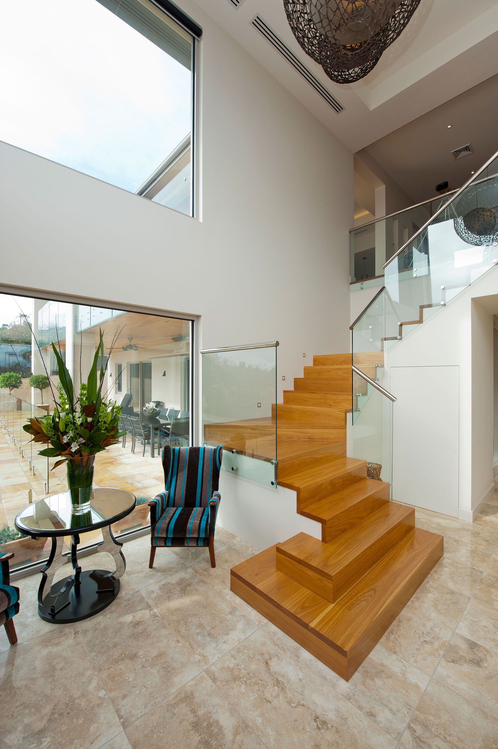 Timber staircase with clear glass balustrade and aluminum hand rail