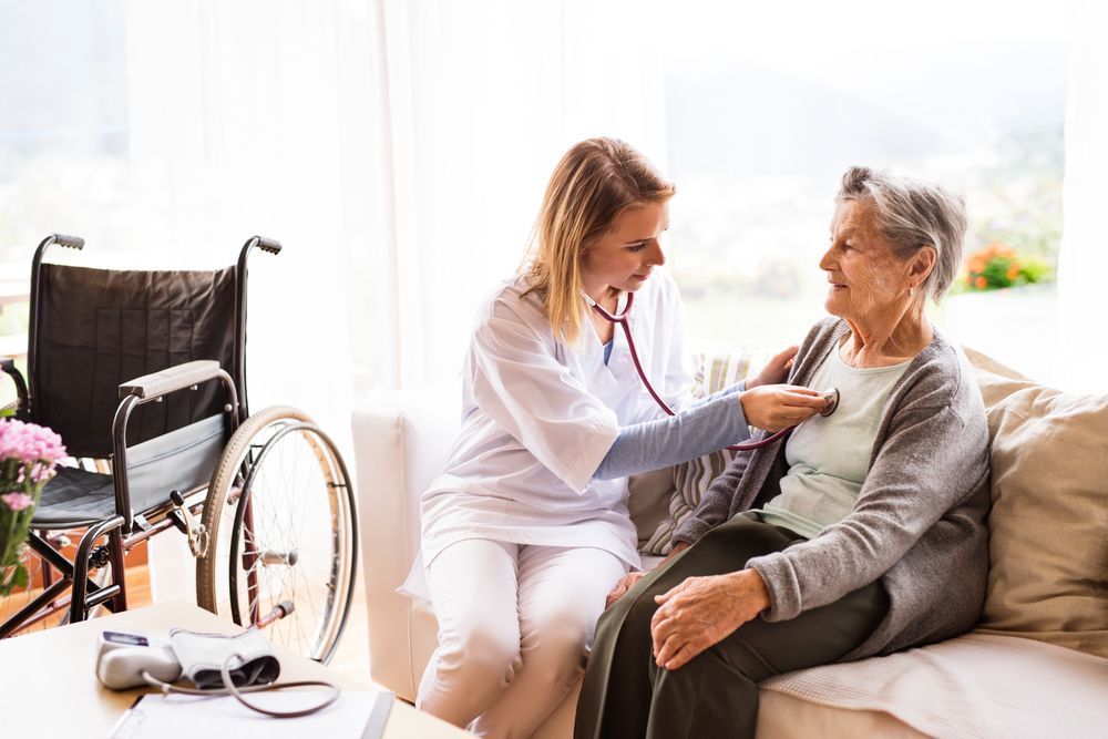 A Young Healthcare Worker Examines an Elderly Woman's Chest With a Stethoscope — Elder Care Connect in Highland Park, QLD