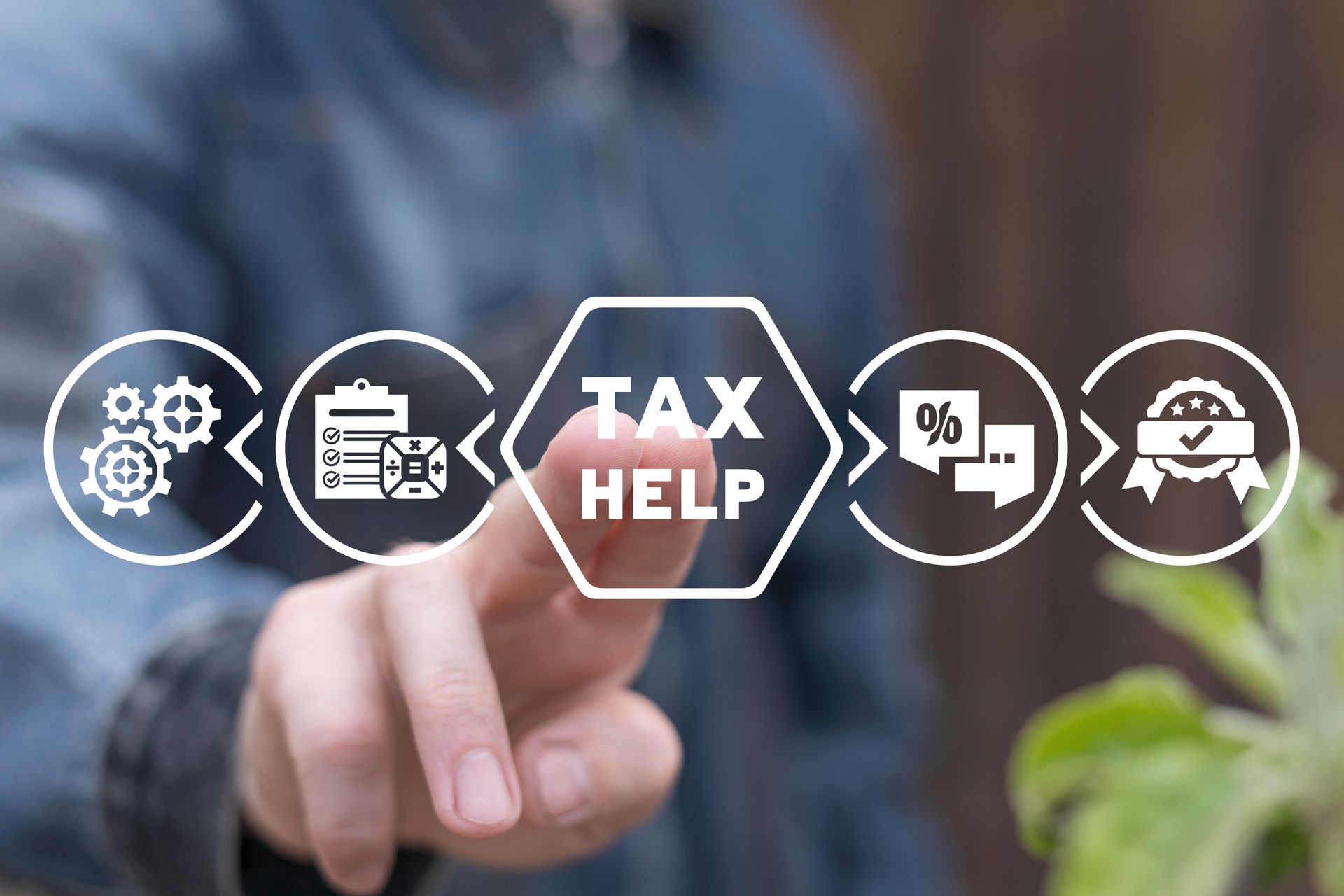 A person is pointing at a screen that says tax help.