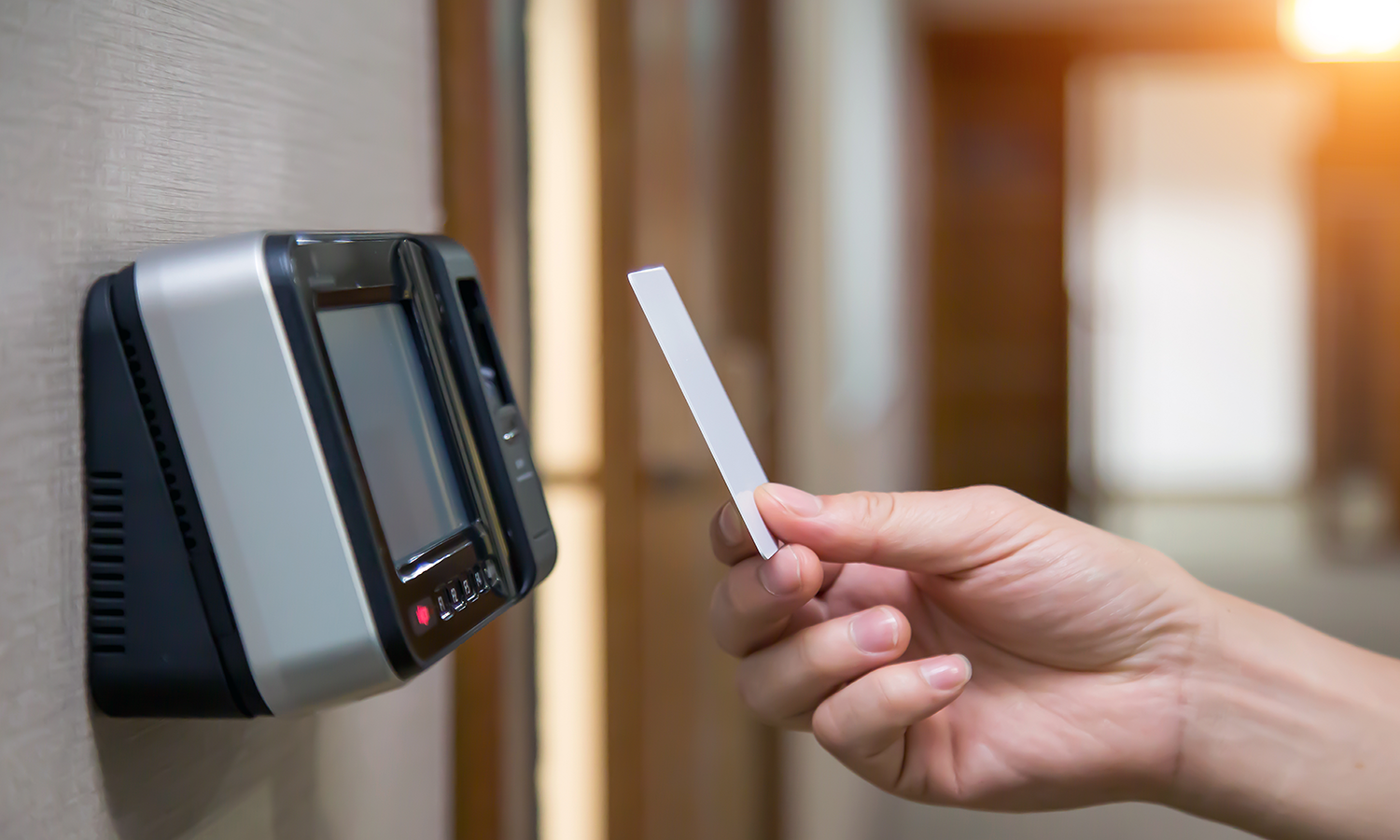 Wooden door with electronic key card reader for access control.