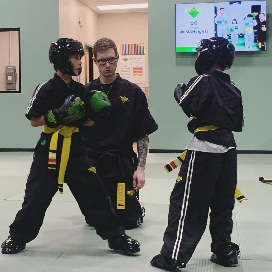 A boy and a girl are practicing taekwondo together.