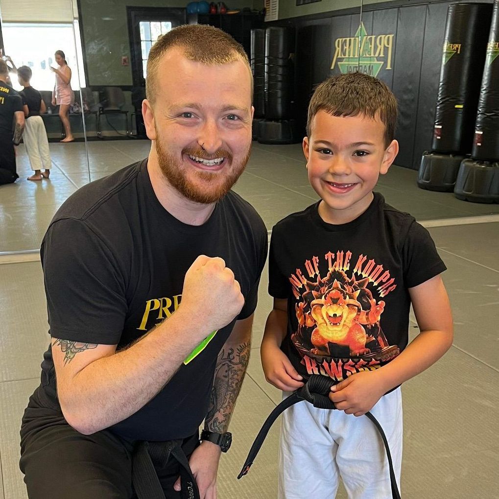 A group of young girls are practicing karate in a gym.