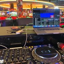 A laptop computer is sitting on top of a dj mixer.