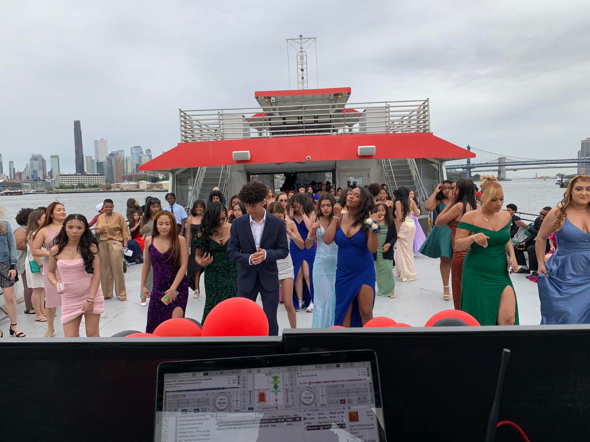 A group of people are dancing on a boat.