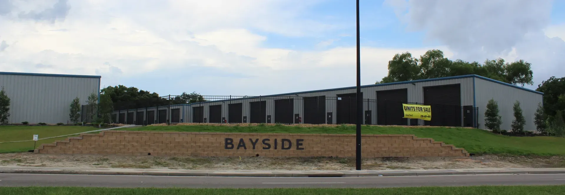 bayside luxury garages facility and street sign