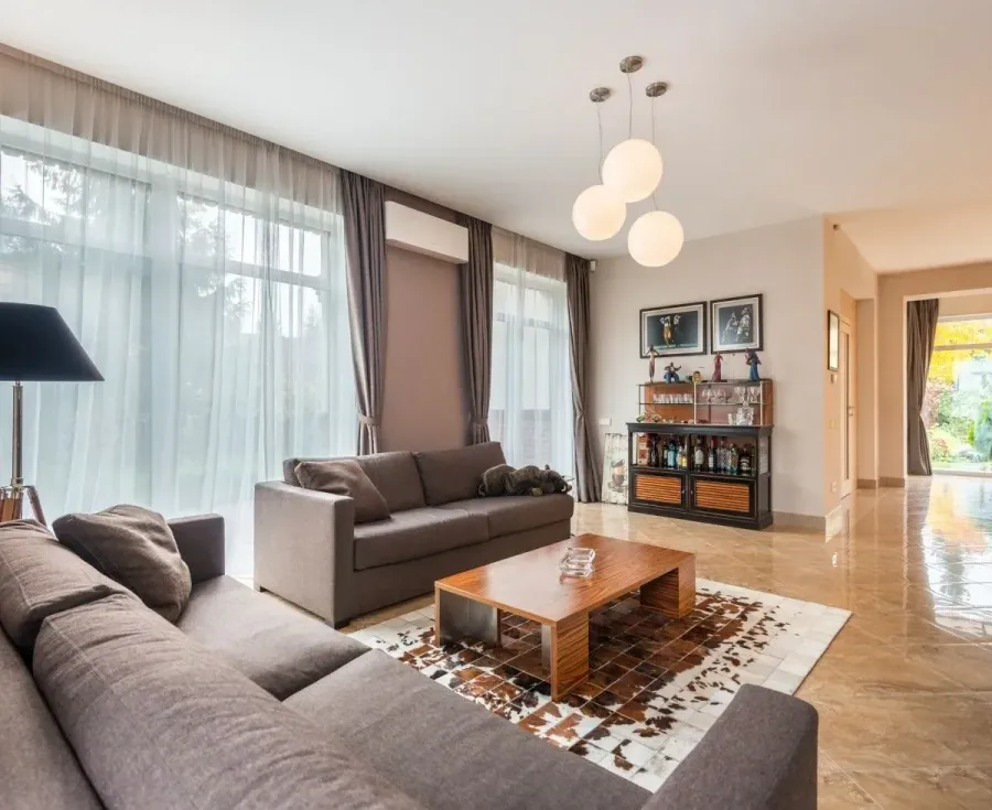A living room with a couch , coffee table and rug.