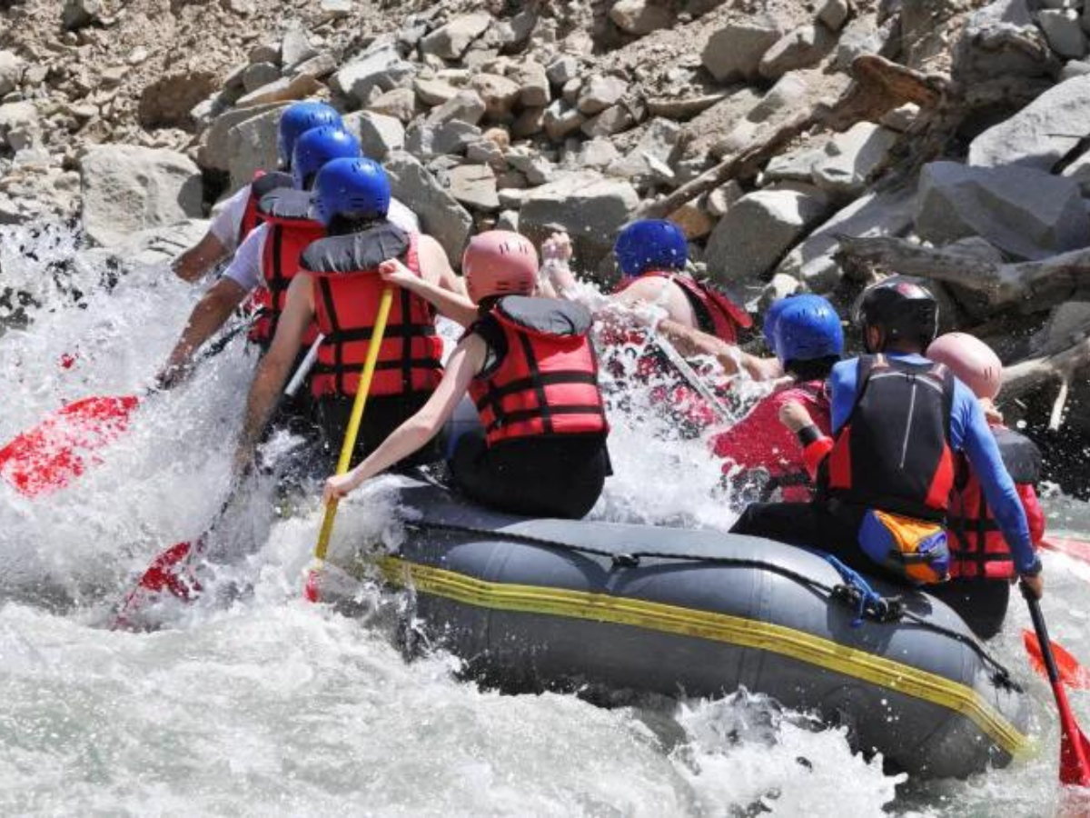 A group of people are rafting down a river