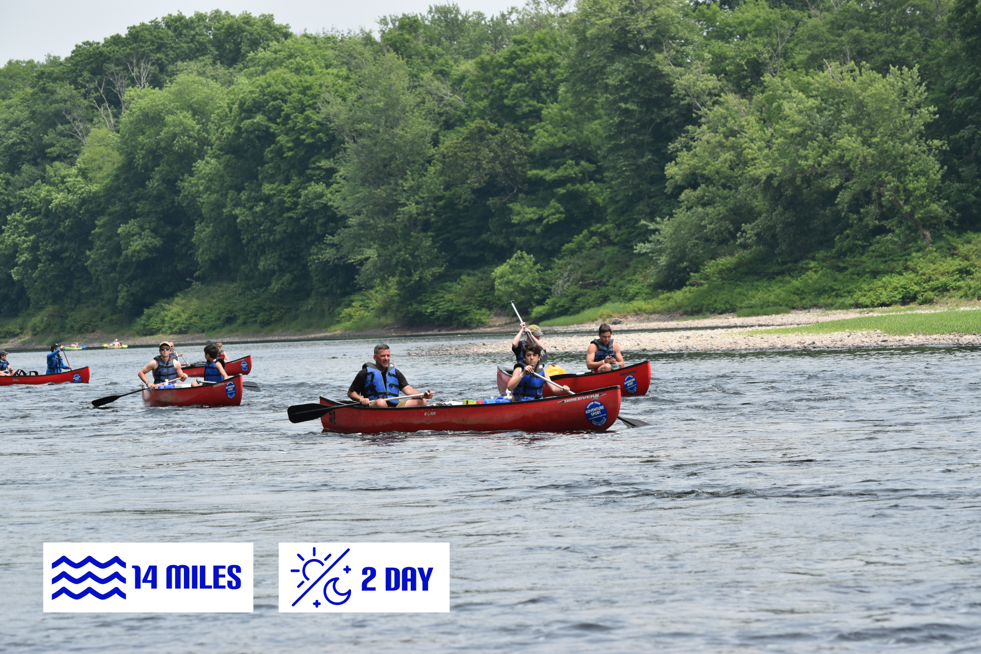 A group of people are rowing canoes down a river with adventure sports' multi day trips