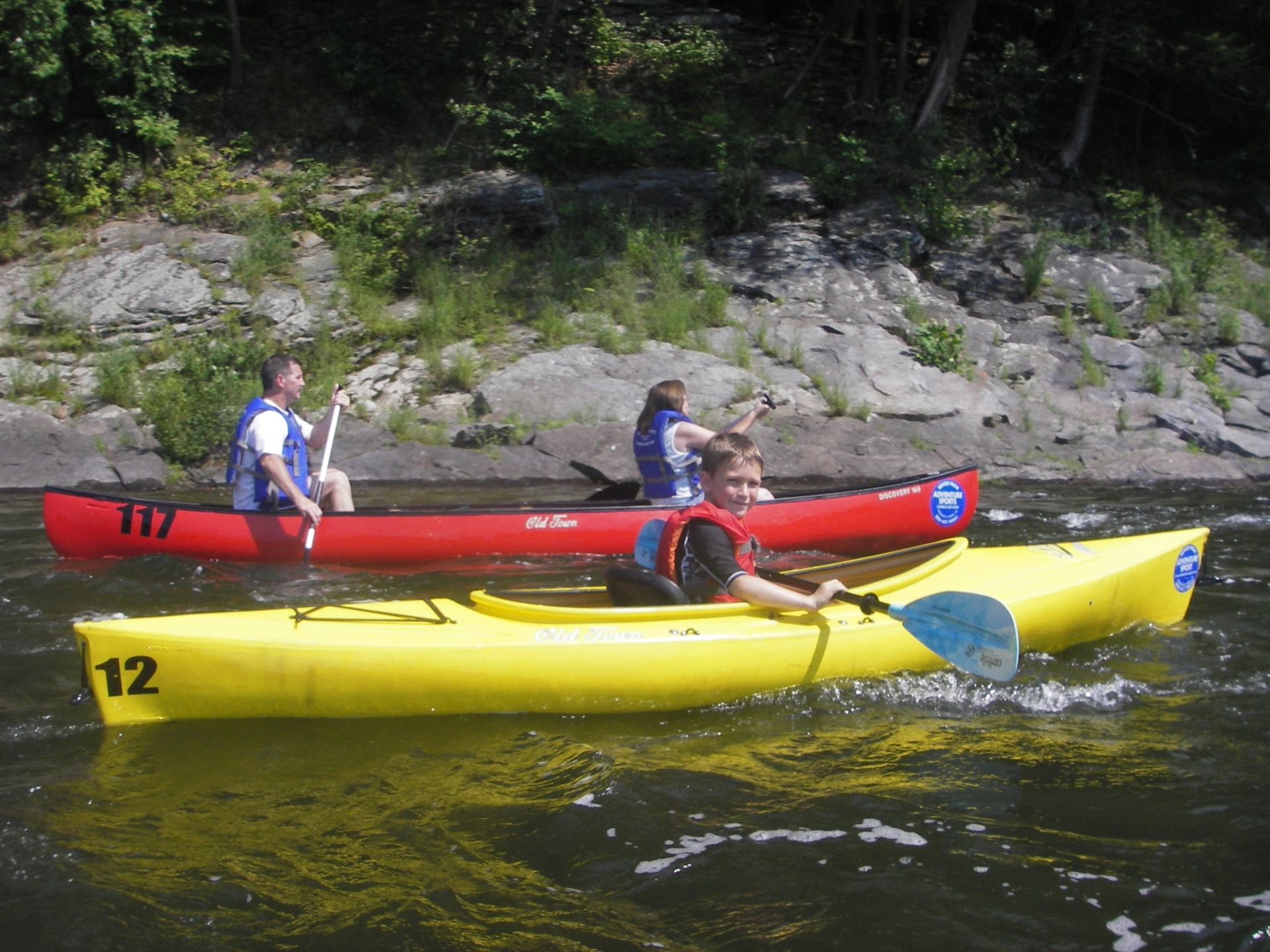 A yellow kayak with the number 12 on it