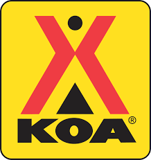 A red and black logo for koa on a yellow background near adventure sports