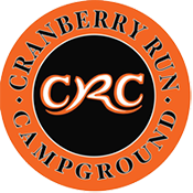 An orange and black logo for cranberry run campground near adventure sports