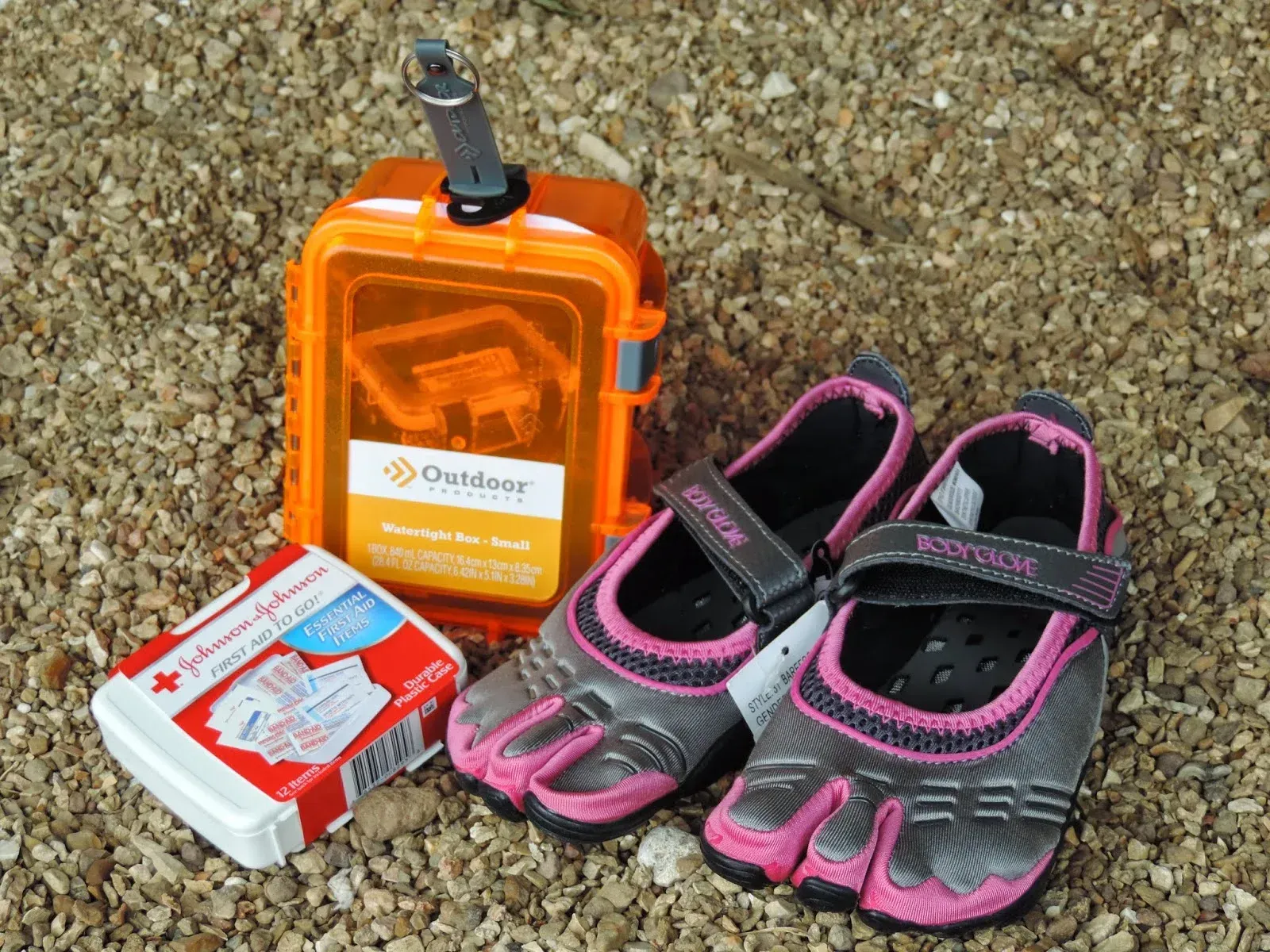 A pair of river shoes next to other essential whitewater rafting supplies.