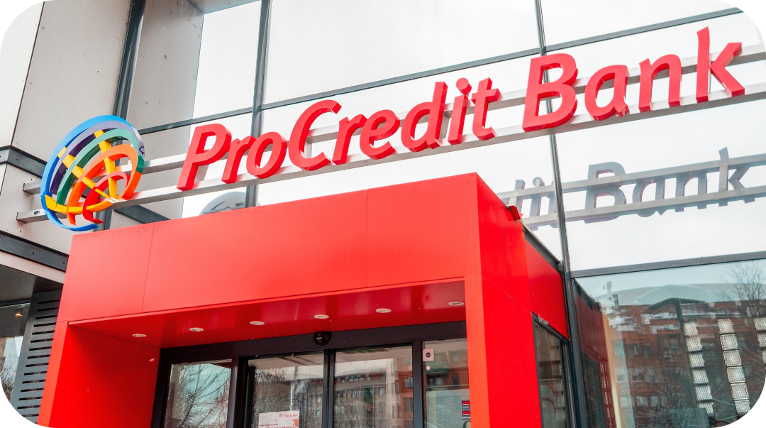 ProCredit Bank building with red sign and entrance, logo on the left.