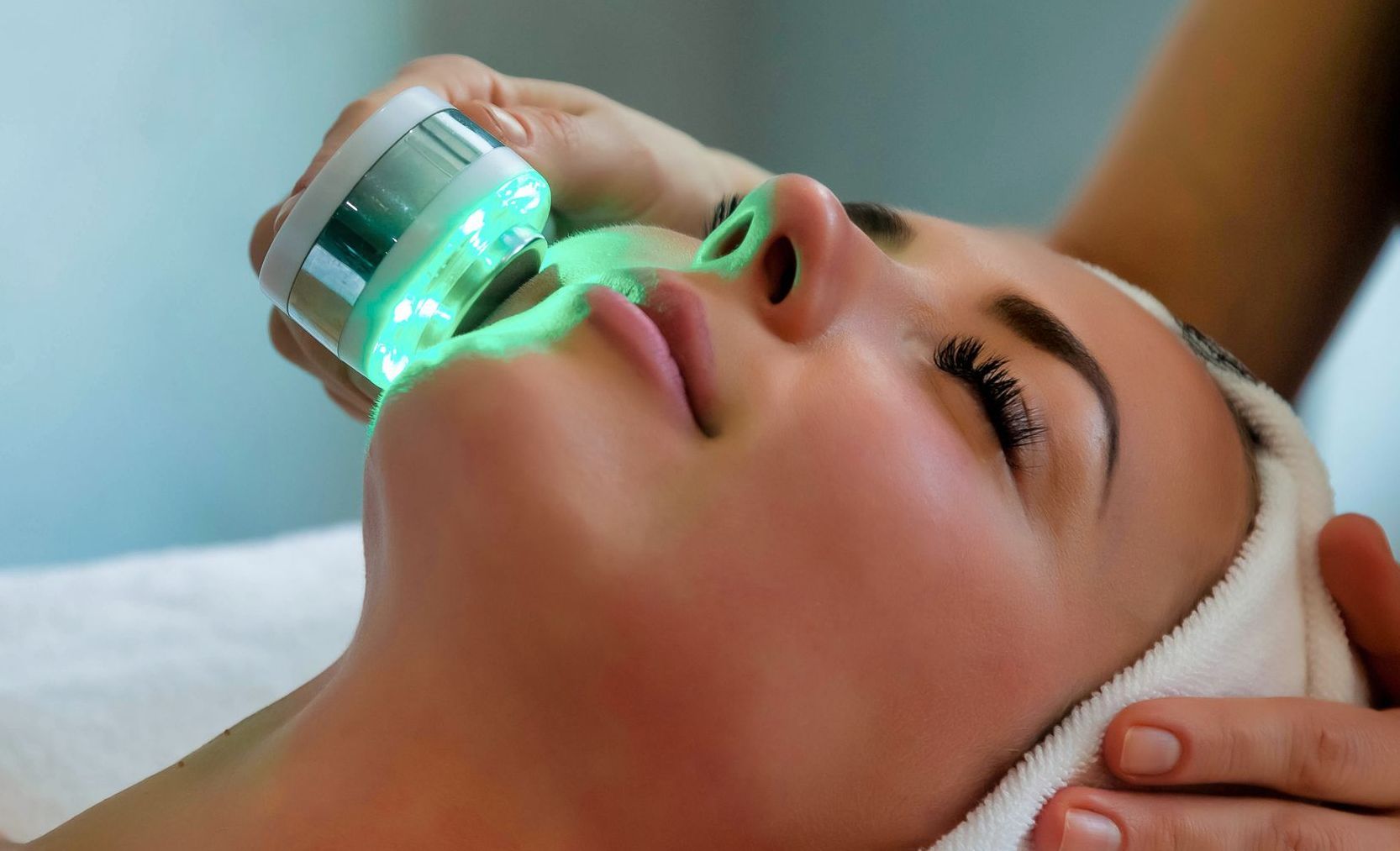 A woman is getting a facial treatment at a spa.