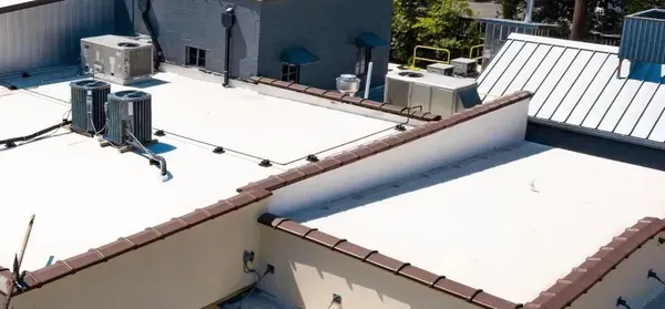 An aerial view of a roof of a building with a white roof.