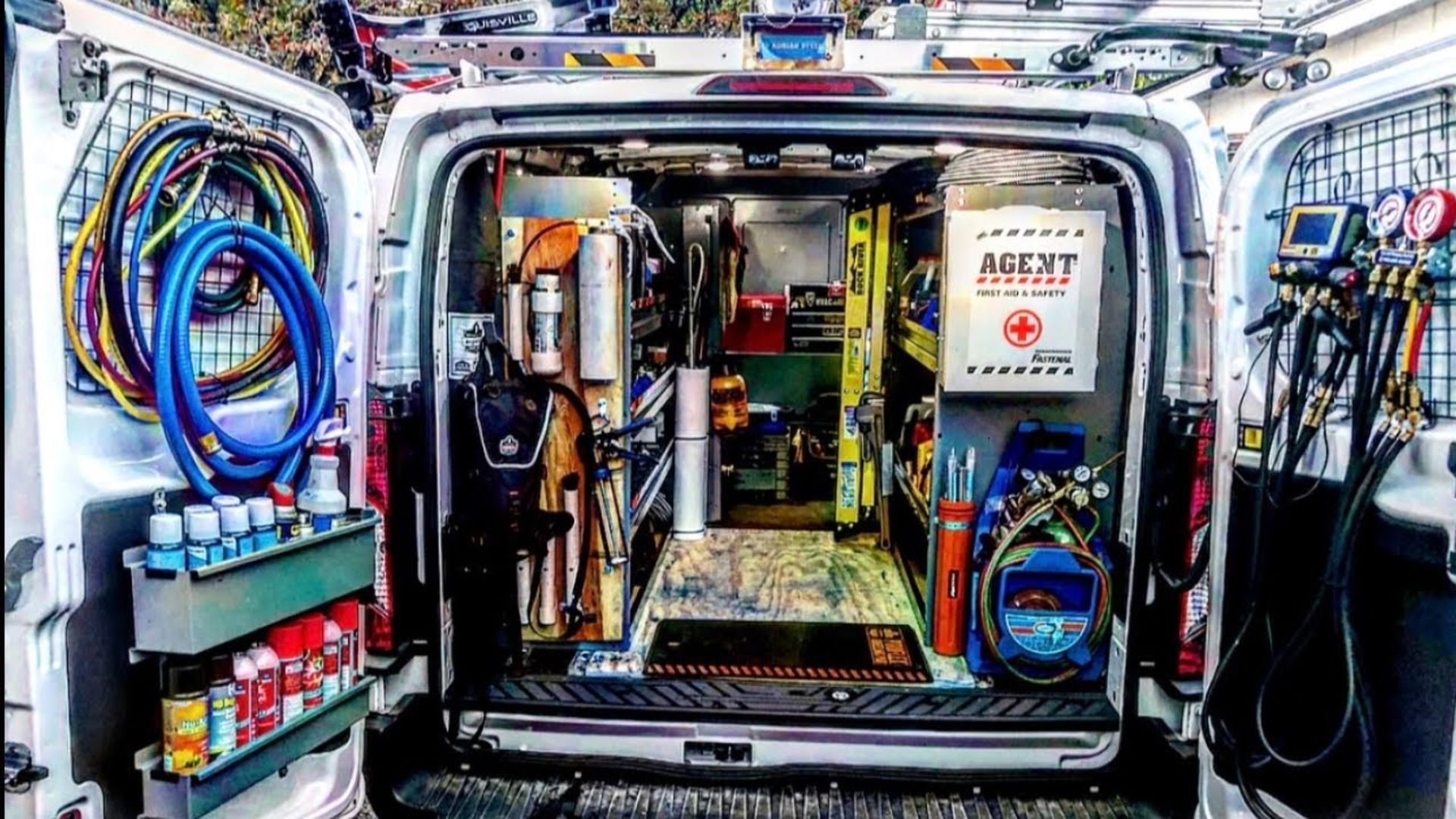 The inside of a van filled with tools and equipment.