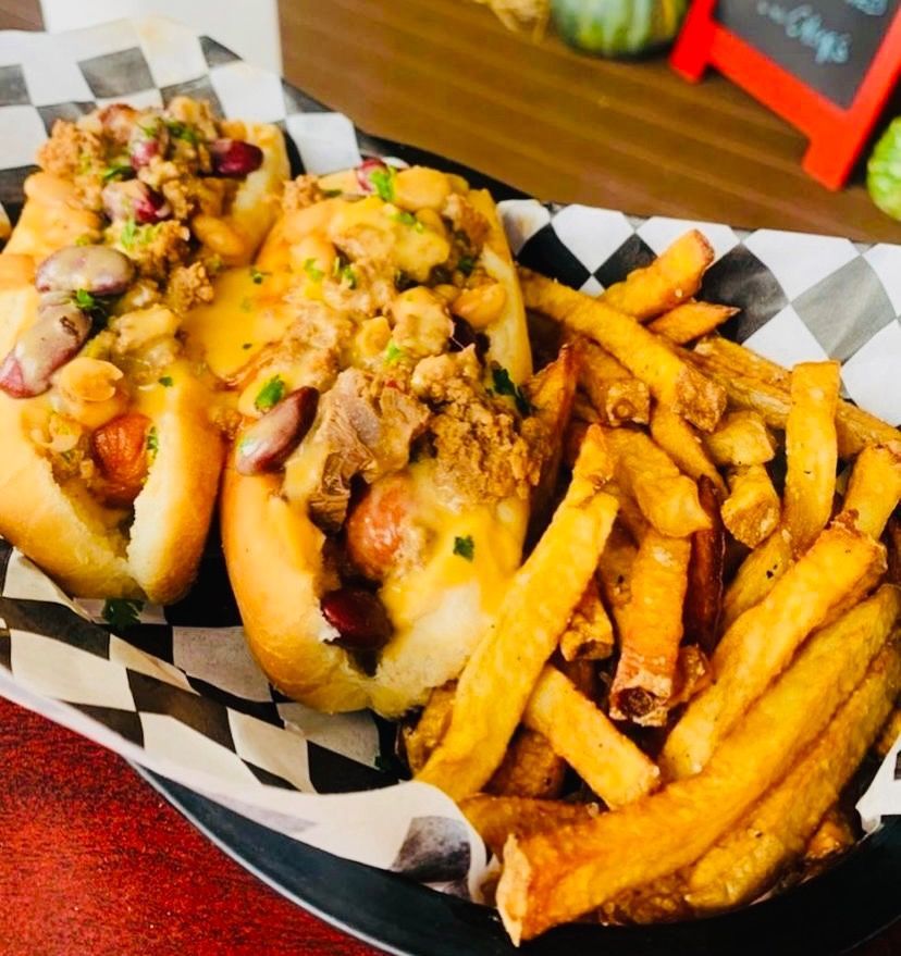 Two hot dogs and french fries in a basket