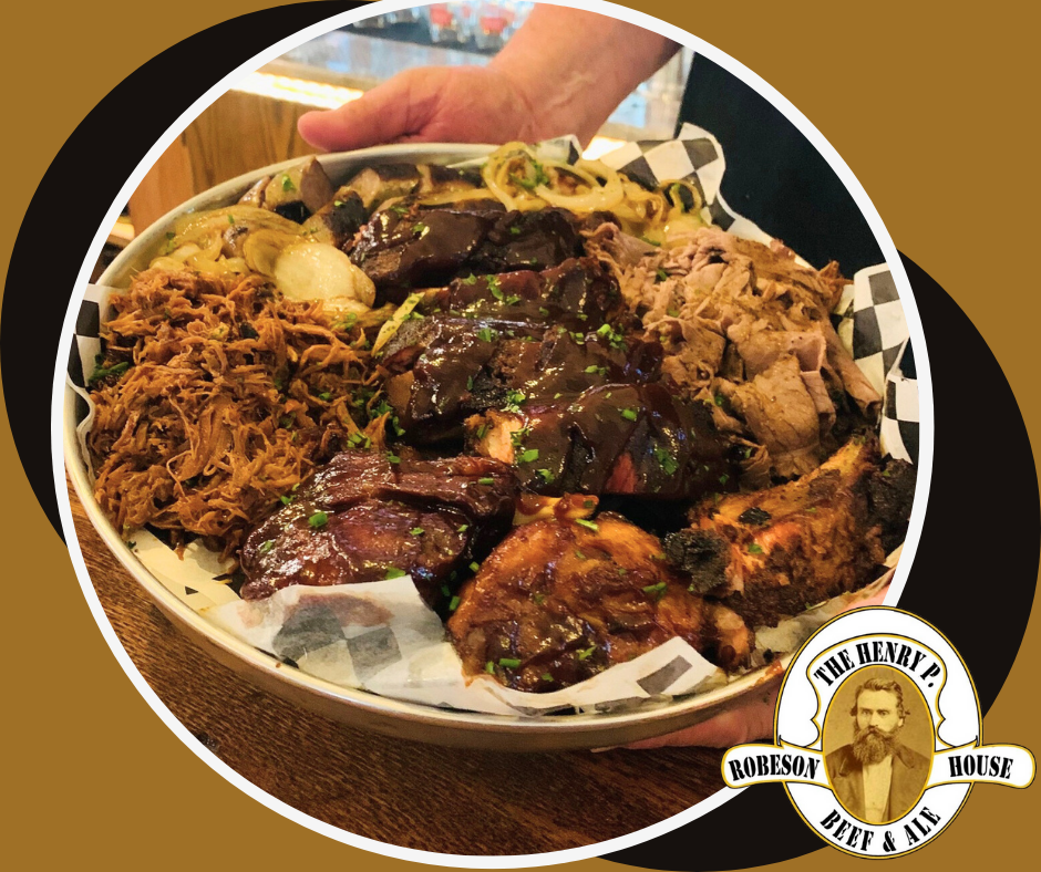 A person is holding a plate of food with a man 's face on it.