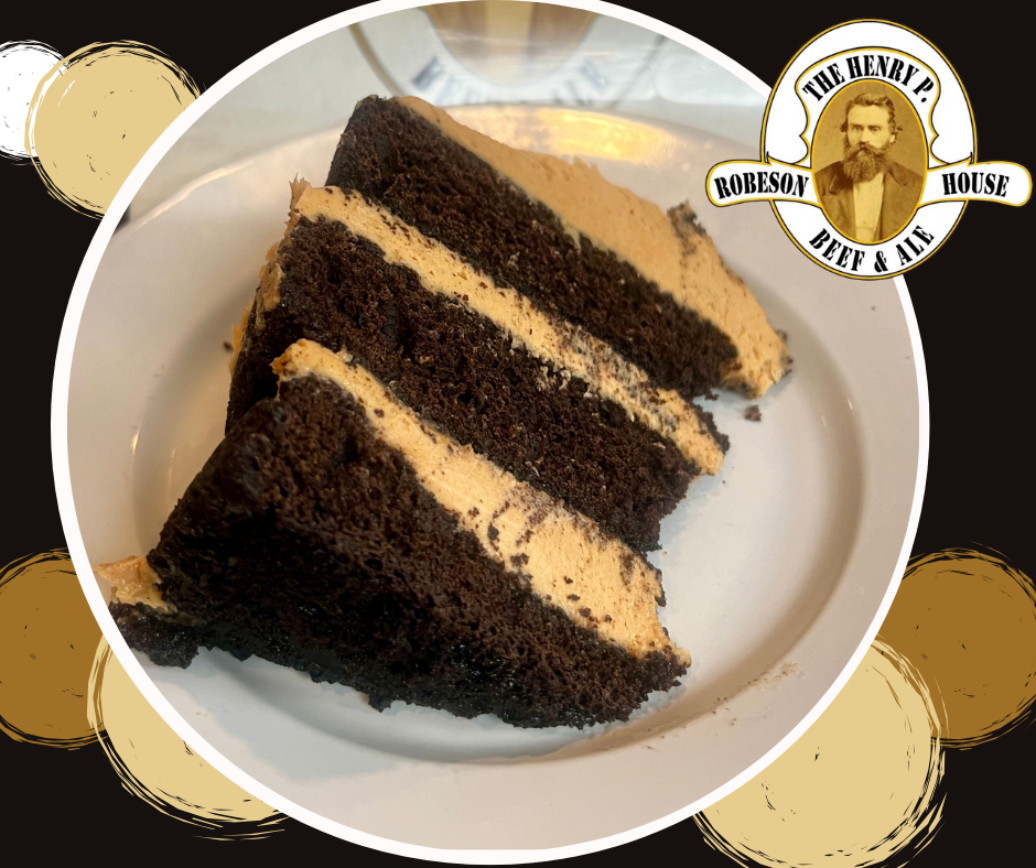 A slice of chocolate cake is on a white plate