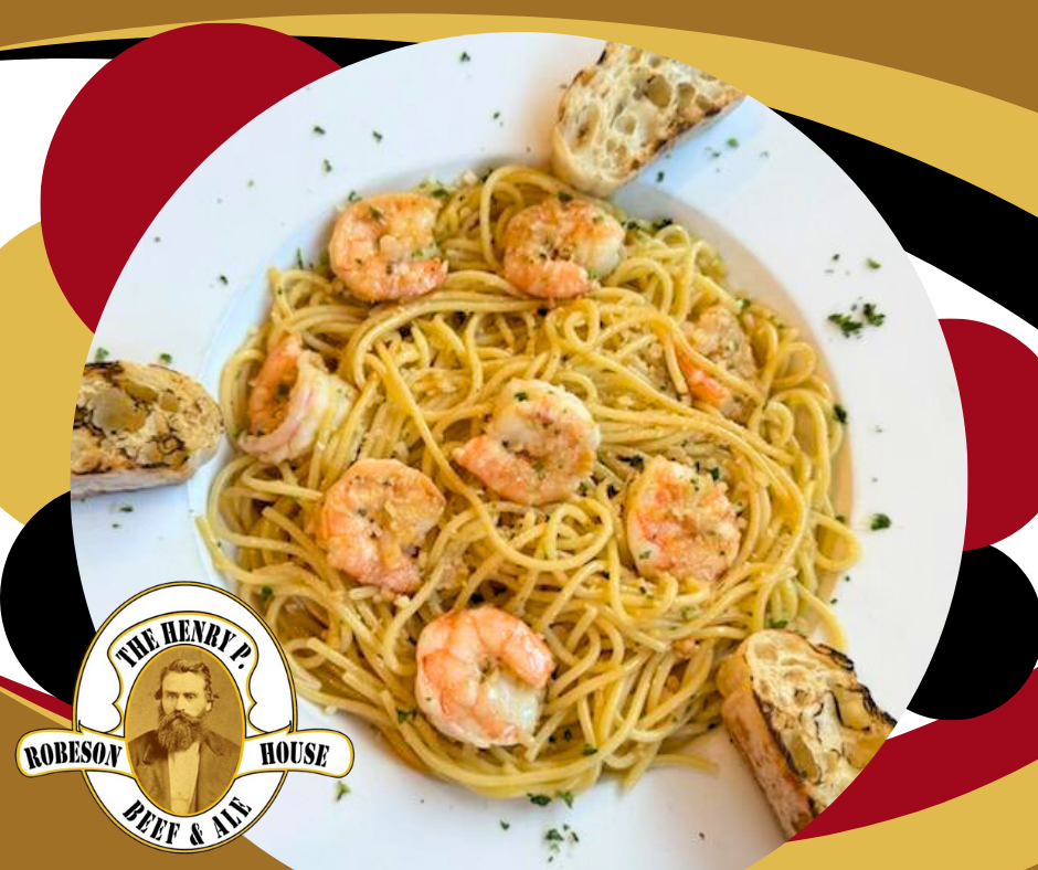 A plate of spaghetti with shrimp and garlic bread