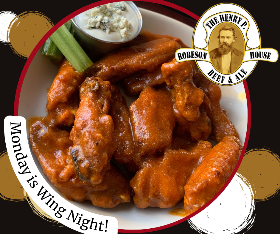 A plate of chicken wings with a sticker that says monday is wing night