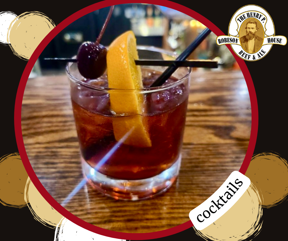 A cocktail with a cherry and a slice of lemon