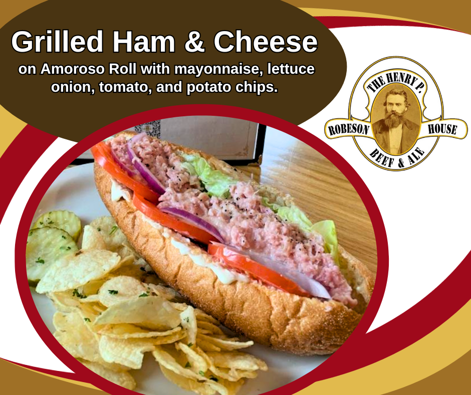 Grilled ham and cheese on amoroso roll with mayonnaise lettuce onion tomato and potato chips