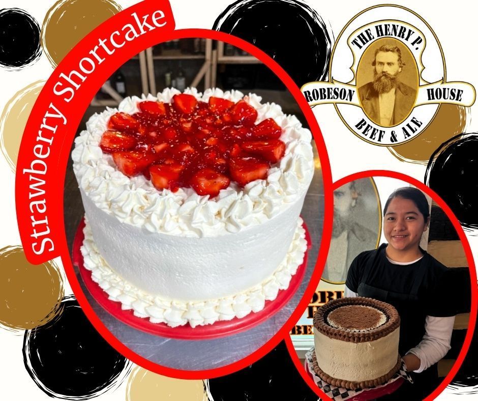 A strawberry shortcake with whipped cream and strawberries on top