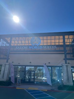 A large building with a lot of windows and a sign that says salon world suites.