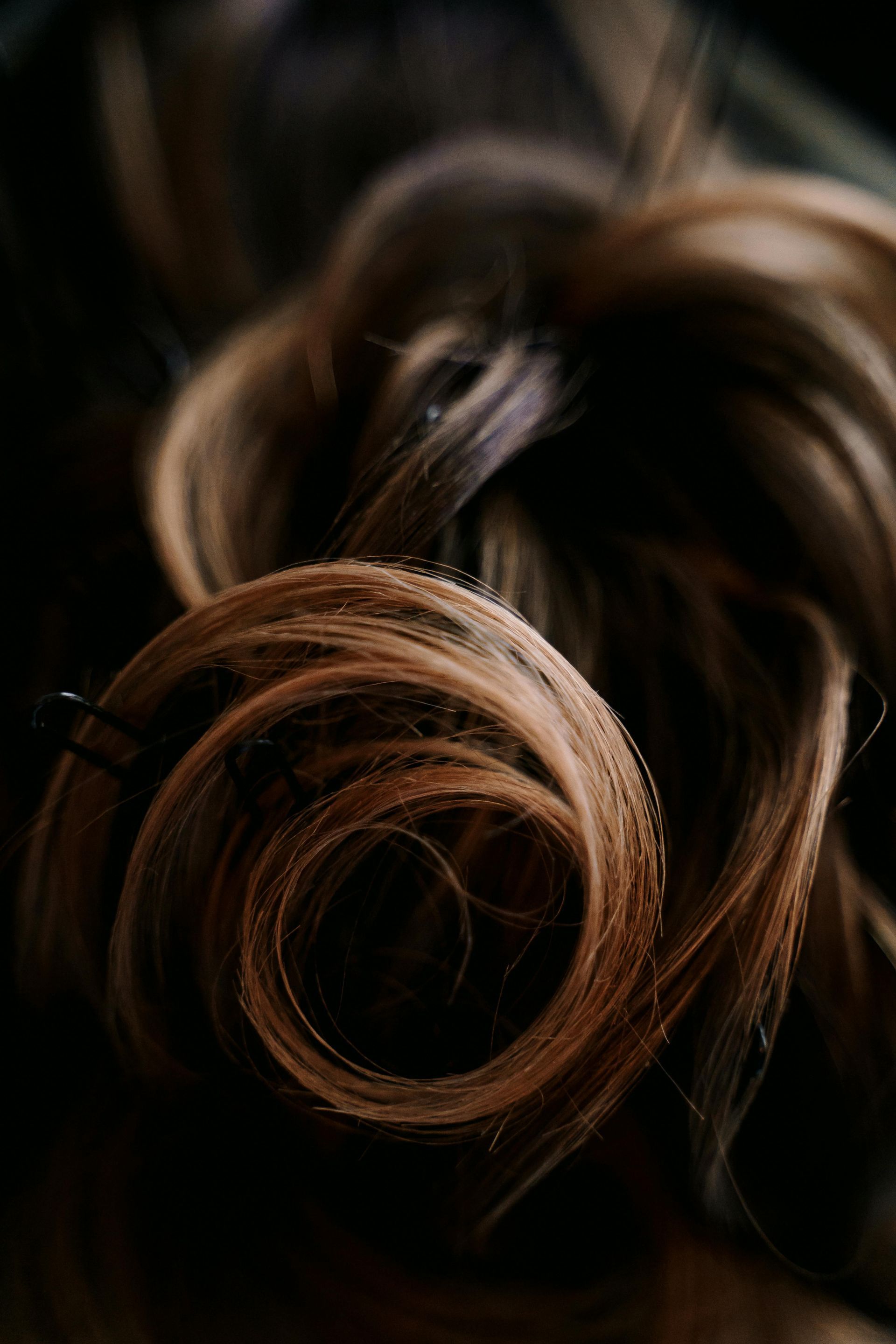 A close up of a woman 's hair in a bun.