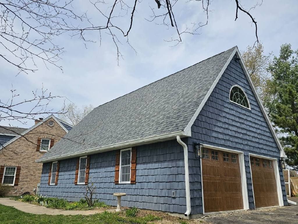 garage with new shingle roof