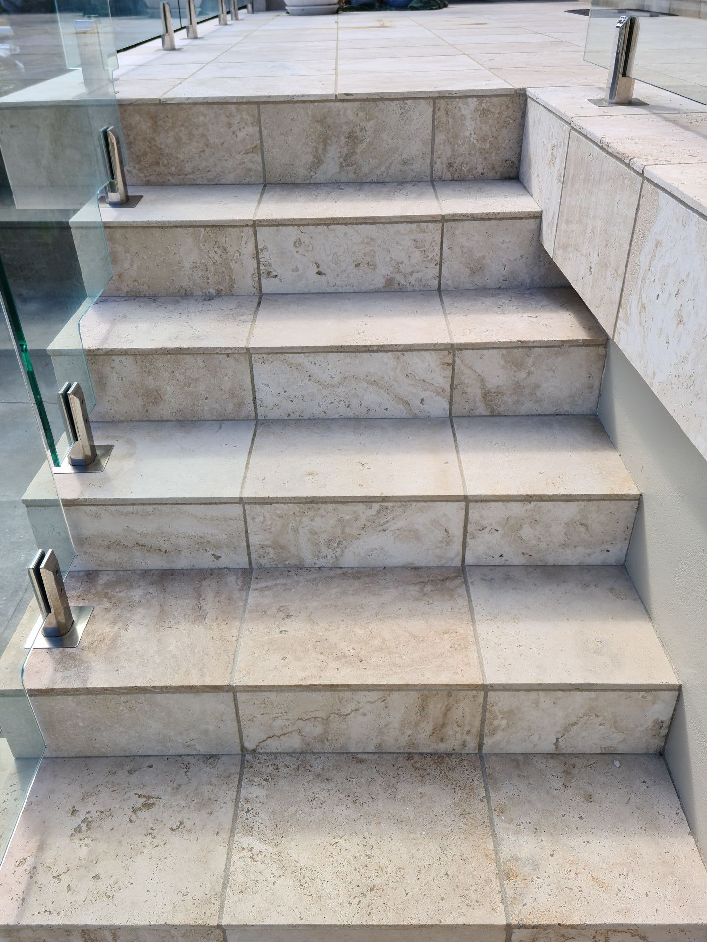 A close up of a set of stairs with a glass railing — South Coast Flooring in Berkeley, NSW