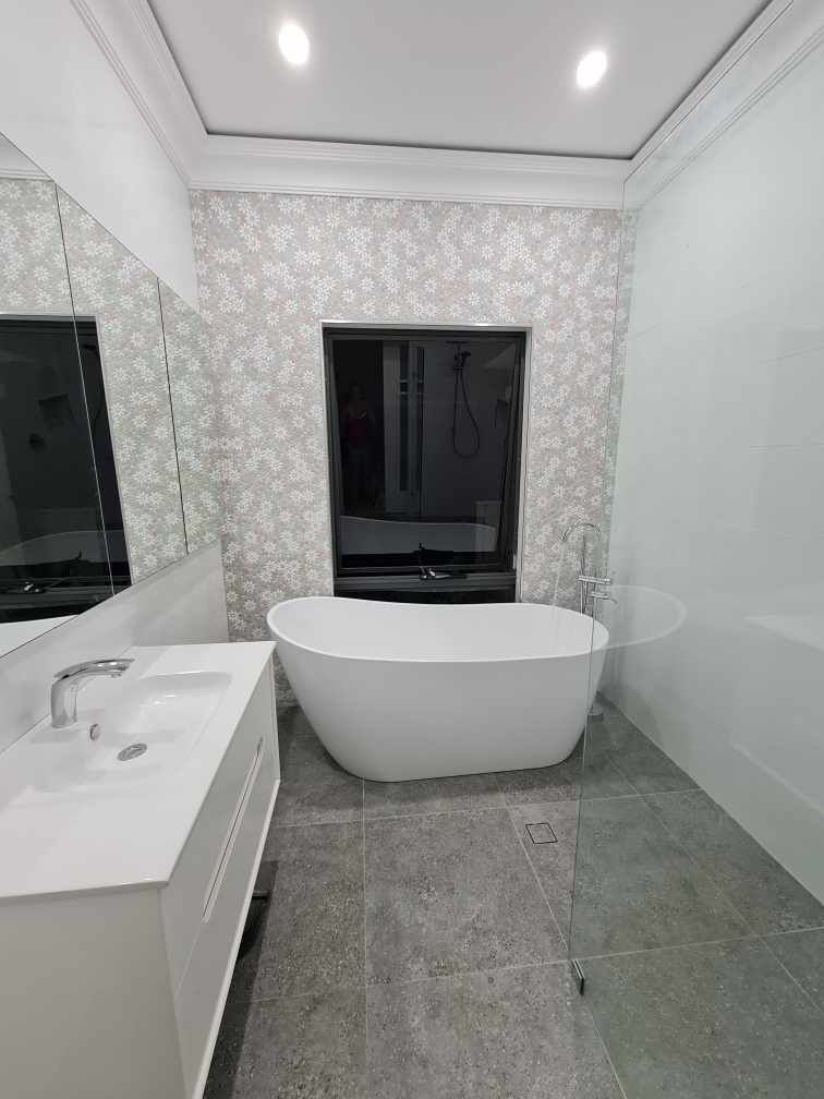A bathroom with a bathtub , sink , mirror and walk in shower.