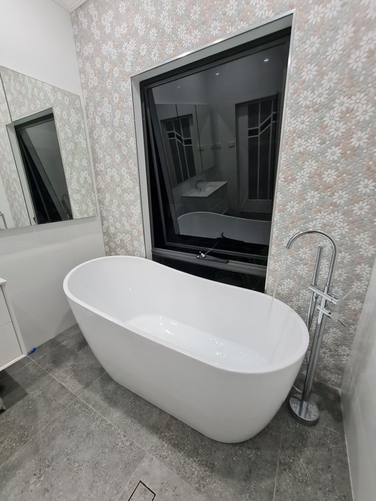 A Bathroom With a Toilet and a Bath — South Coast Flooring in Berkeley, NSW