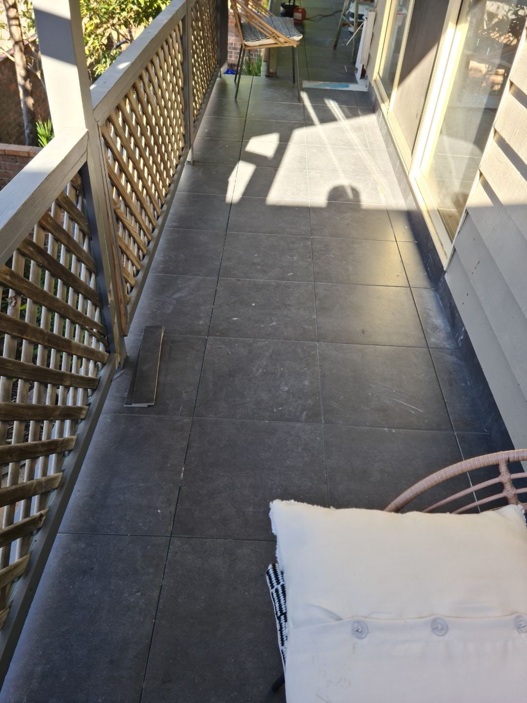 A balcony with a chair and a table on it