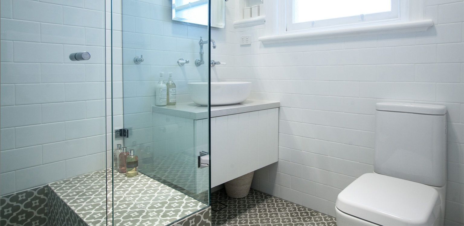A Bathroom With a Toilet, Sink and Walk in Shower — South Coast Flooring in Thirroul, NSW