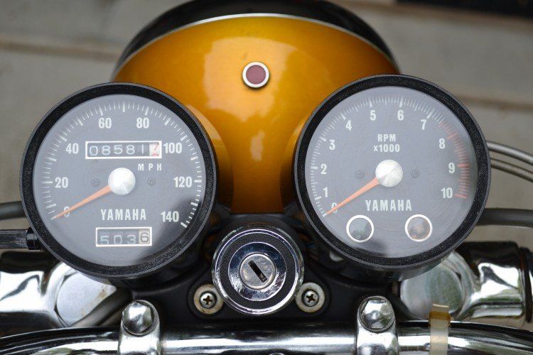 Showing the two gauges, top of headlight, and the ignition key, of the 1971 Yamaha XS1B